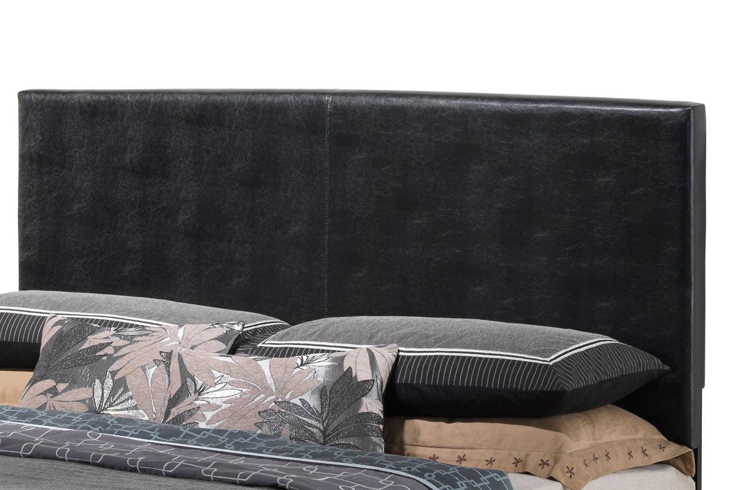 The Elegant Platform Bed For Relaxed Spaces features a black upholstered headboard behind pillows and bedding, styled with a mix of solid and leaf-patterned pillowcases in neutral tones.