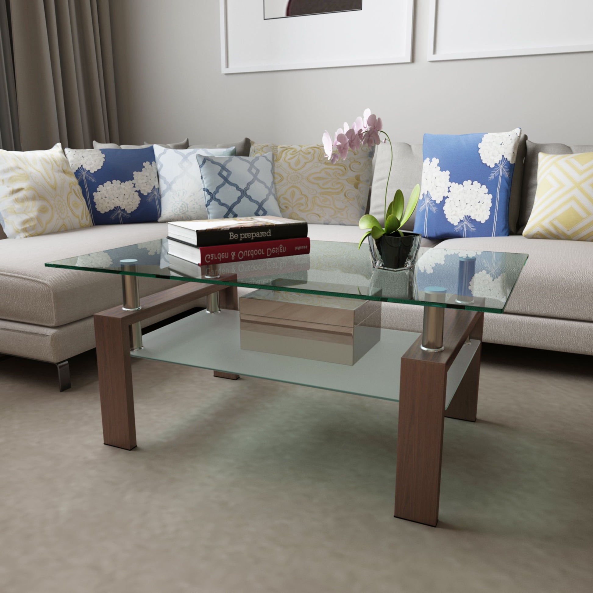 A modern living room features the Rectangle Coffee Table, Modern Side Center Tables For Furniture, displaying books, a small box, and a potted orchid, surrounded by an L-shaped sofa with blue, white, and yellow patterned cushions.