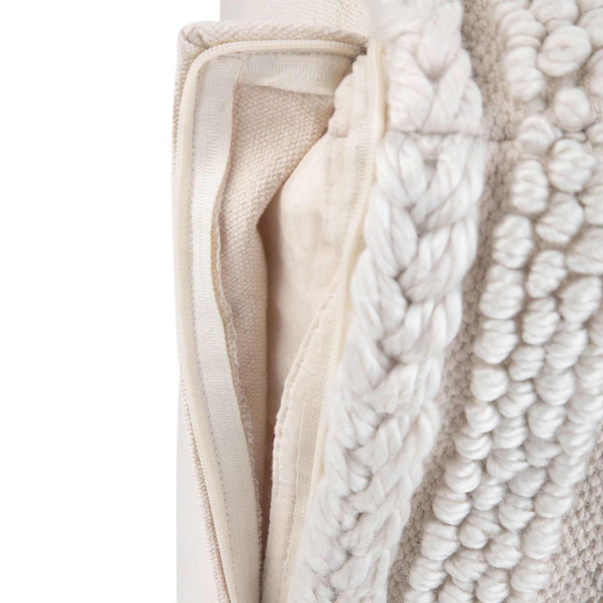 Close-up of the Sommer - Handcrafted Square Pouf, featuring a cream textured, chunky woven and tufted fabric with a visible zipper and inner pillow insert.
