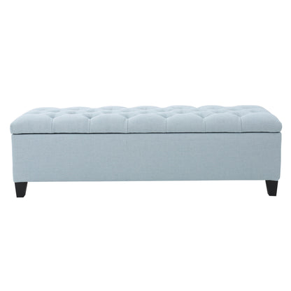 The Glouster Contemporary Storage Ottoman features a light blue upholstered, button-tufted top, short black legs, and handy storage, shown against a white background.