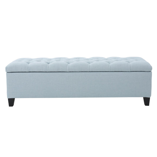 The Glouster Contemporary Storage Ottoman features a light blue upholstered, button-tufted top, short black legs, and handy storage, shown against a white background.