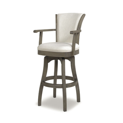 The Williams - Swivel Bar Stool With Armrests features a wooden frame, light beige upholstered seat and backrest, armrests, a swivel base, four curved legs, and a circular footrest.