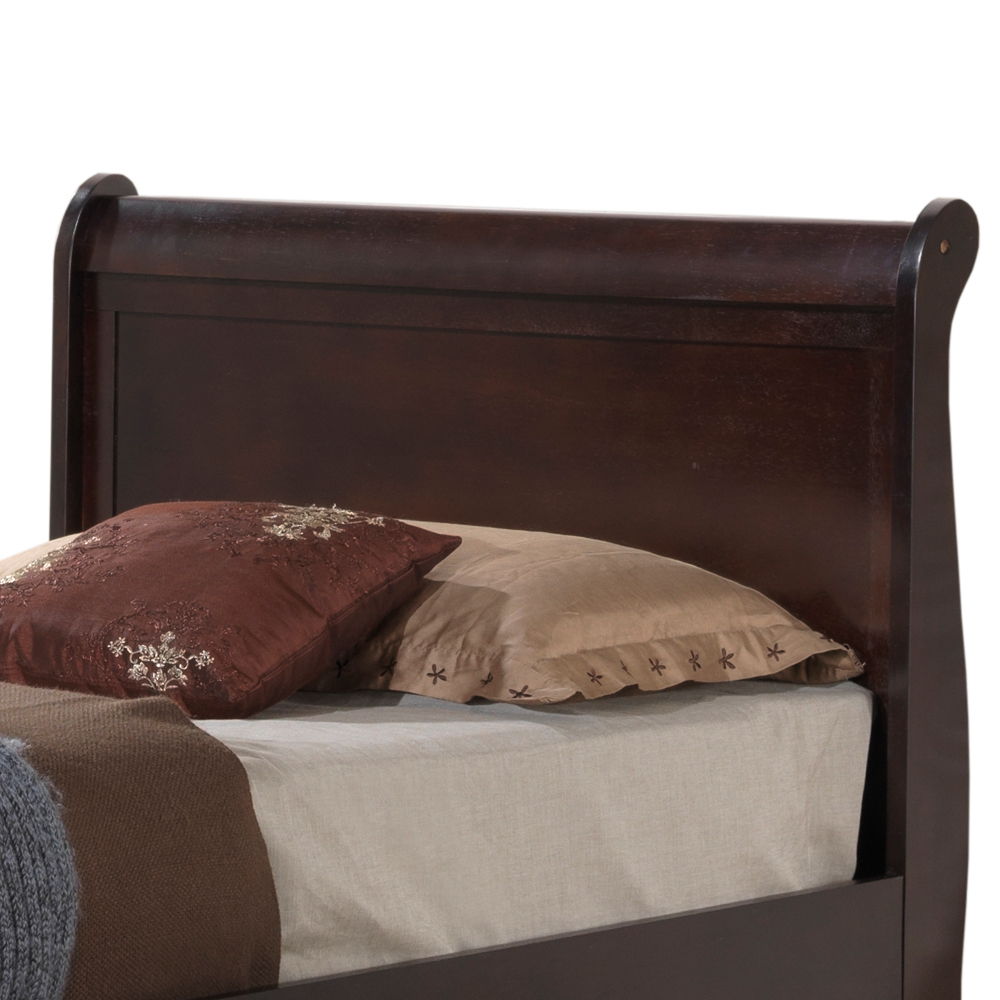 A close-up of the Elegant Trundle Bed With Timeless Charm features a dark wood frame, high headboard, beige bedsheet, and two pillows—one plain beige and one brown with embroidered floral designs.