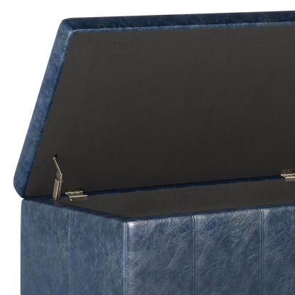 A close-up of the Dover - Upholstered Storage Ottoman Bench in blue faux leather, featuring a hinged lid, spacious black interior, textured surface, and visible side stitching.