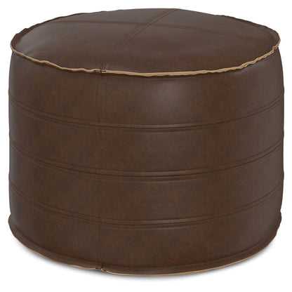 The Brody - Round Pouf is a brown leather ottoman with visible horizontal and cross-stitched seams, a slightly glossy finish, and textured detailing for added style.
