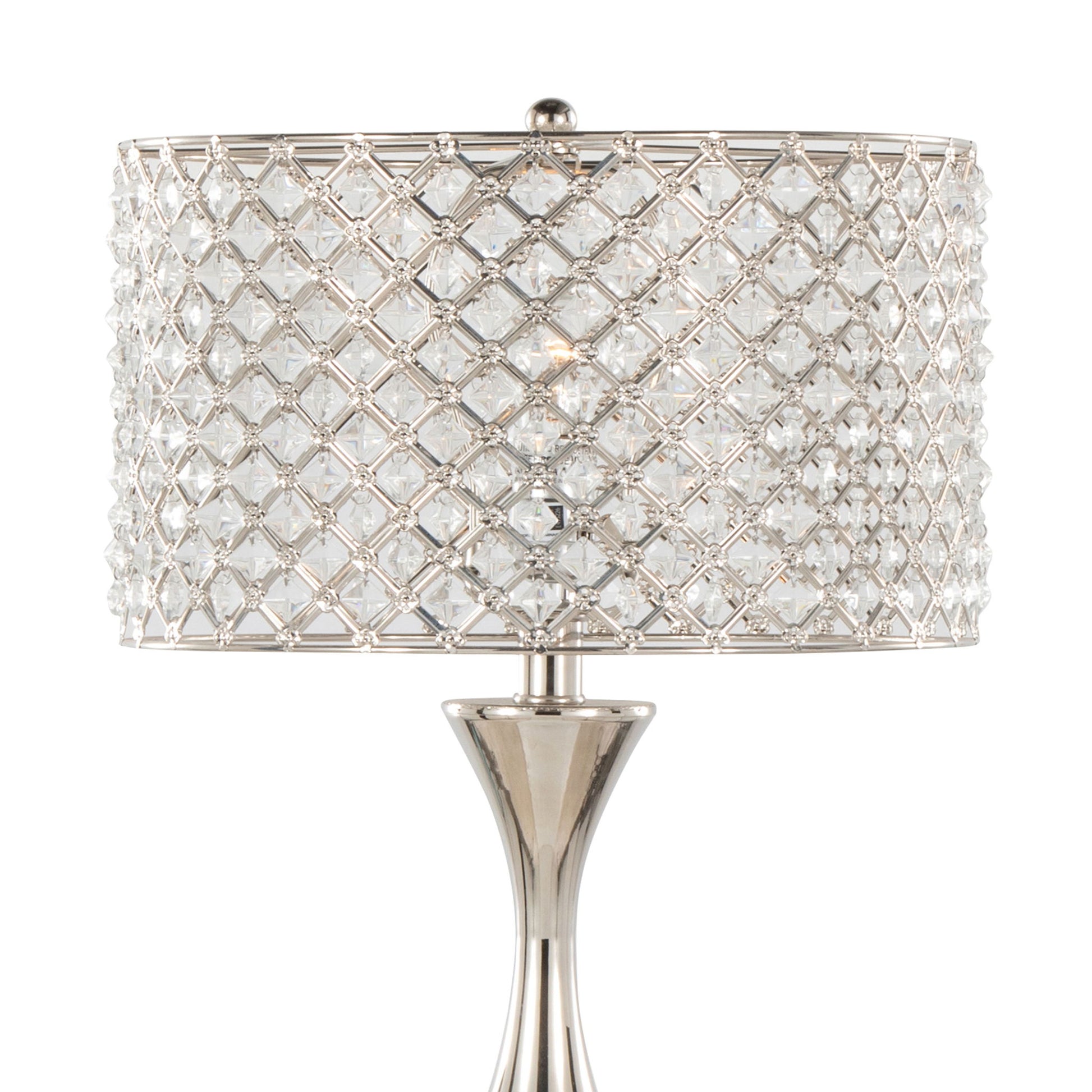 The Topaz - Contemporary Table Lamp features a shiny silver base and a cylindrical shade adorned with clear, faceted crystals in a lattice pattern, creating a sparkling display when lit.