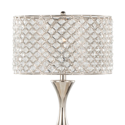The Topaz - Contemporary Table Lamp features a shiny silver base and a cylindrical shade adorned with clear, faceted crystals in a lattice pattern, creating a sparkling display when lit.