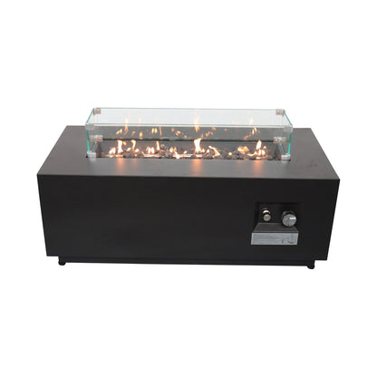 The Outdoor Fire Pit Table With Lid features a sleek rectangular black design, glass wind guard, control knobs, and a visible flame glowing above decorative stones. Enjoy fuel versatility for your outdoor gatherings.