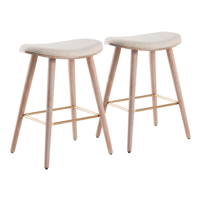 The Saddle - Contemporary Counter Stool (Set of 2) features two modern backless stools with light wood legs, beige curved upholstered seats, and gold metal footrests, displayed against a white background.