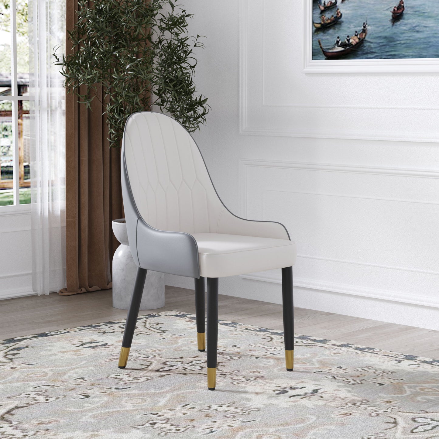 A set of 2 Modern PU Sponge-Filled Dining Chairs with solid wood metal legs stands on a patterned rug by a window with brown curtains, next to a potted plant. A framed painting hangs on the white wall in the bright room.