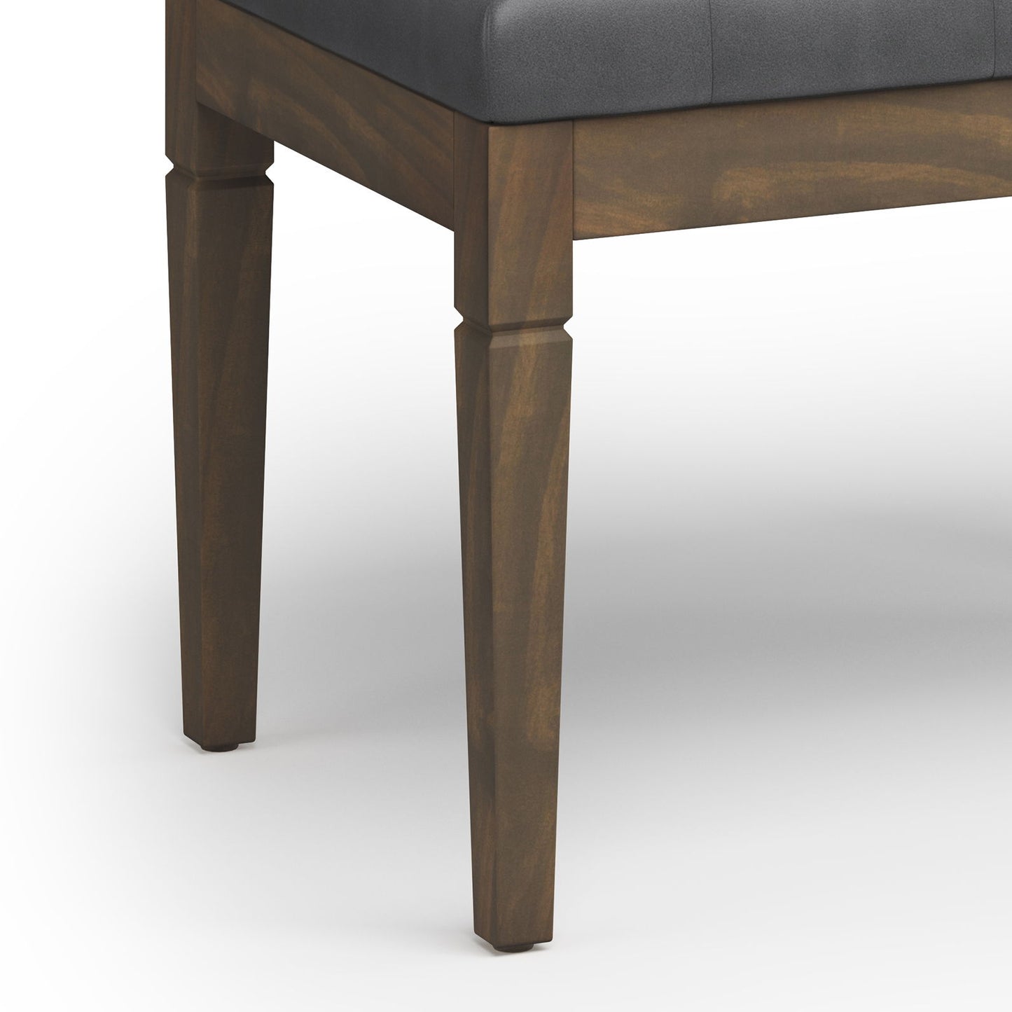 Close-up of the Waverly - Upholstered Tufted Ottoman Bench corner, featuring dark brown legs and a black cushioned seat, set against a white background.