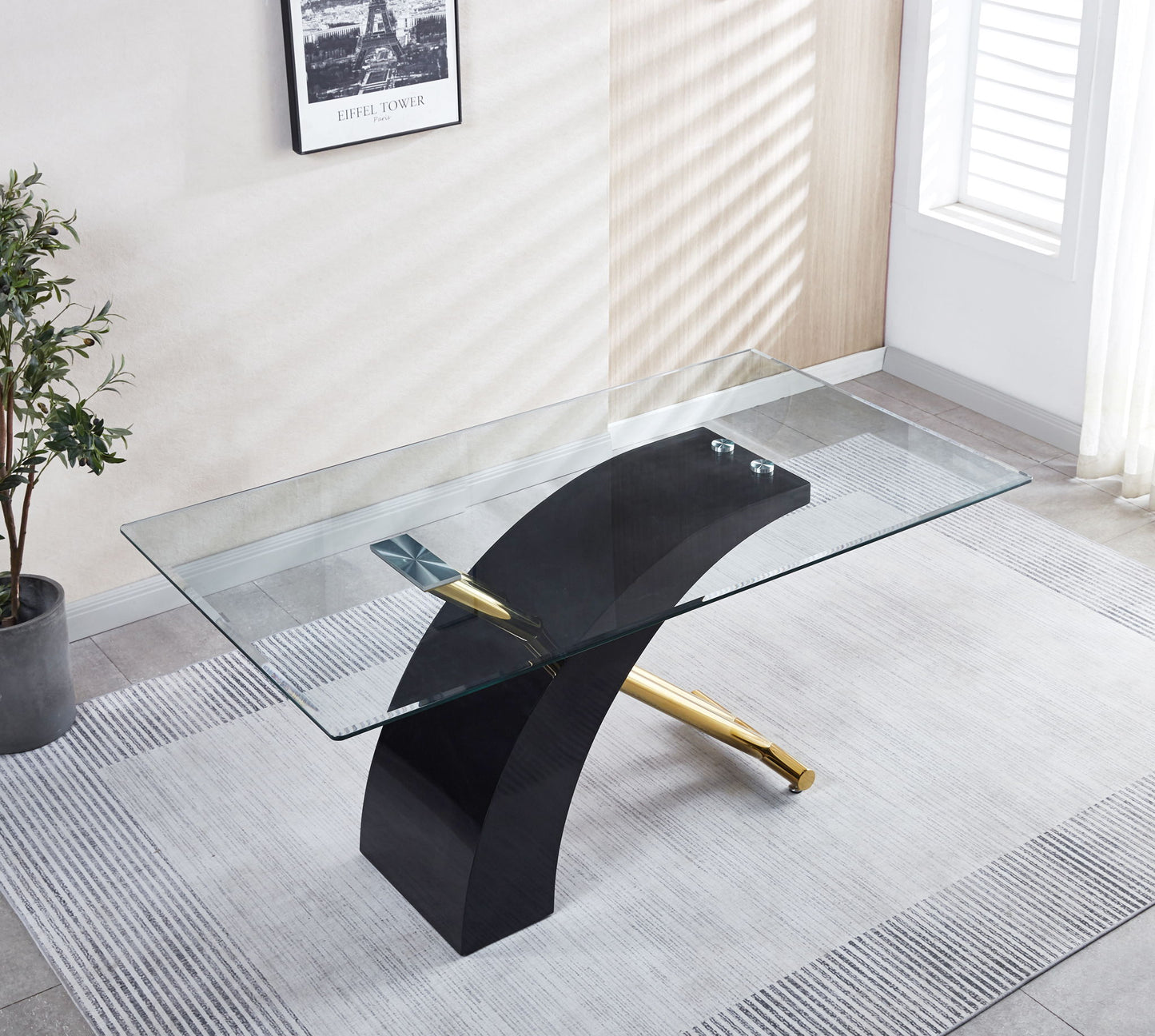 The Stylish Dining Room Table features a luxury glass top and modern black base, creating a chic focal point in a bright room with large windows, white shutters, wall plant, framed artwork, and light gray rug.