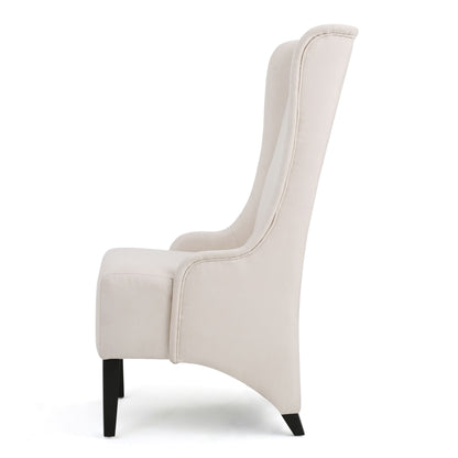 Side view of the Alight Upholstered Dining Chair, featuring a high back, light beige fabric, and black-stained birch wood legs, shown against a plain white background. Sold as a set of 2.