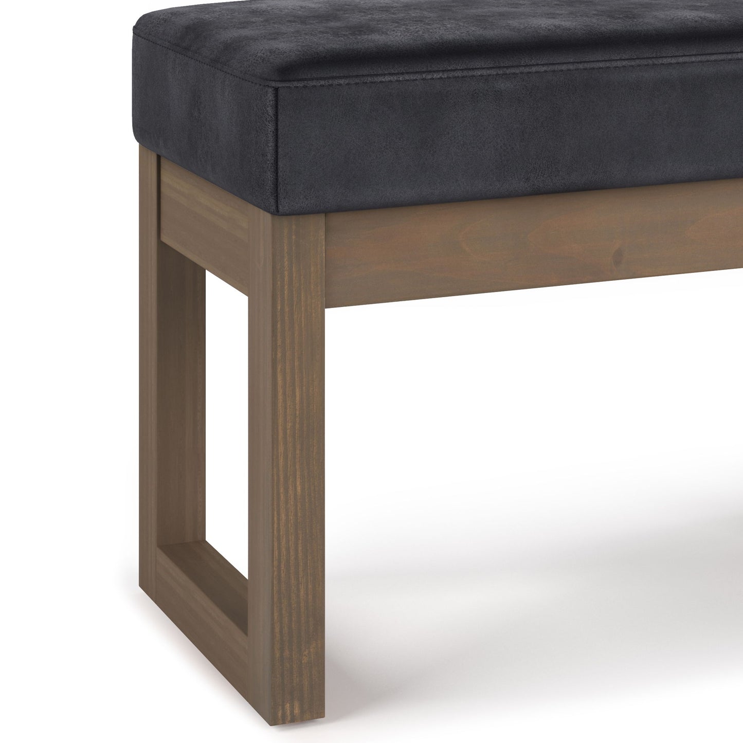 A close-up of the Milltown - Upholstered Ottoman Bench featuring a rectangular wooden frame and black cushioned seat, displayed on a white background.