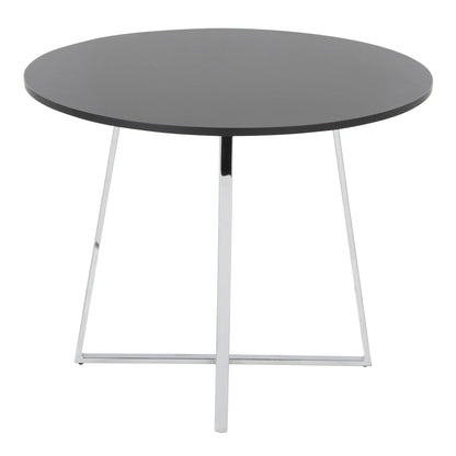 The Cosmo - Canary Contemporary Dining Table is round and dark gray, featuring a smooth top with metal legs in a minimalist, modern X-shaped base.
