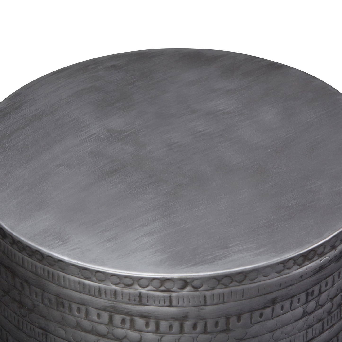 A close-up view of the Johnsen - Handcrafted Large Metal Accent Table, featuring a smooth round top and a decorative embossed edge.