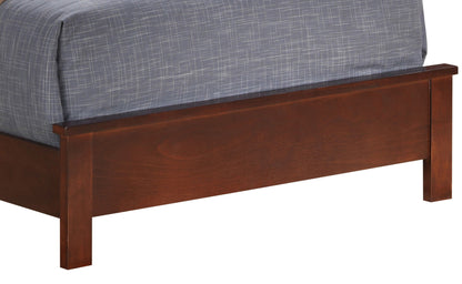 A close-up of the footboard on the Bed With Transitional Design Stylish, featuring a dark brown wooden finish and topped with a gray and white patterned comforter.