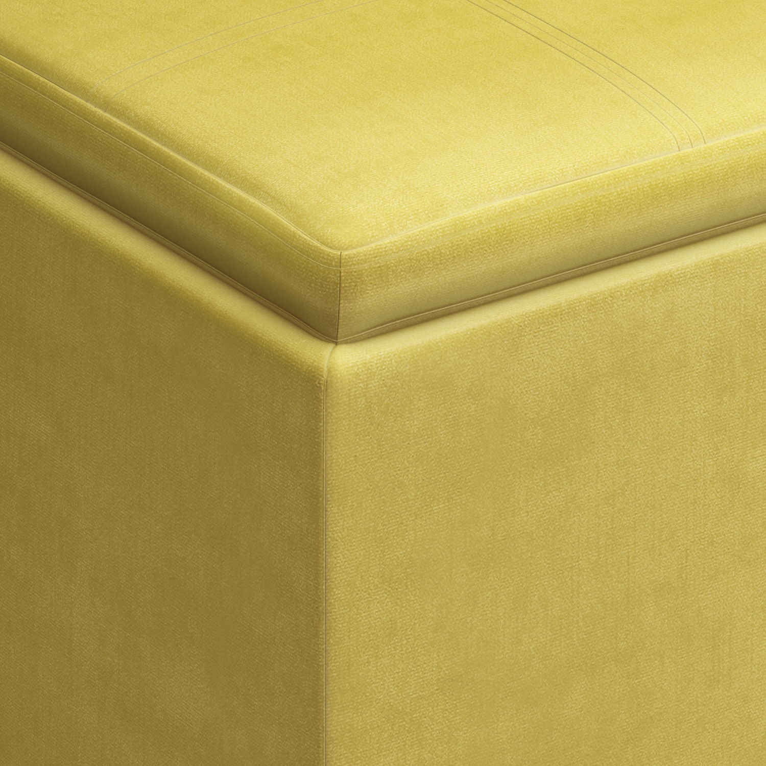 Close-up of the corner of the Rockwood - Upholstered Cube Storage Ottoman With Tray, highlighting its smooth yellow fabric texture and neat top stitching.