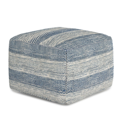 The Clay - Square Pouf, Upholstered features a textured fabric cover with horizontal blue and beige stripes. This square pouf has a soft, cushioned look and is shown against a plain white background.