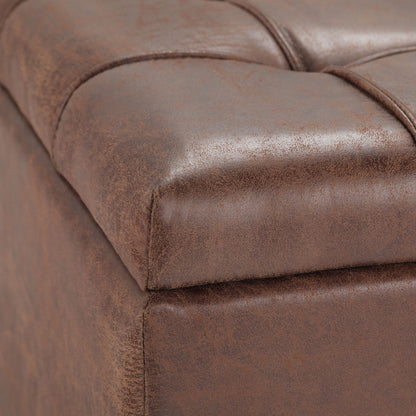 Close-up of the Harrison - Upholstered Coffee Table Storage Ottoman, featuring brown leather with visible stitched seams and a tufted, cushioned surface for a smooth, vintage look.