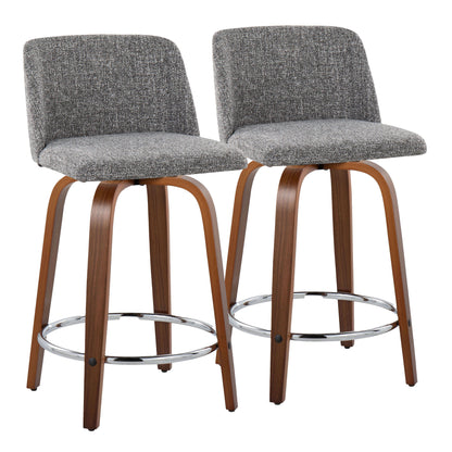 The Toriano set includes two mid-century modern counter stools featuring curved wooden legs, a round chrome footrest, and swivel seats. The textured gray fabric upholstery complements the sleek metal and warm wood design for a contemporary look.