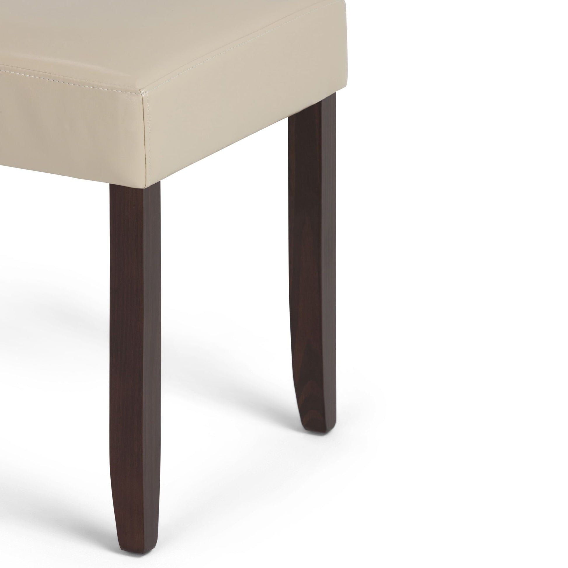 A close-up of the Acadian Upholstered Parson Dining Chair (Set of 2) features a beige cushioned seat and dark brown wooden legs against a white background.
