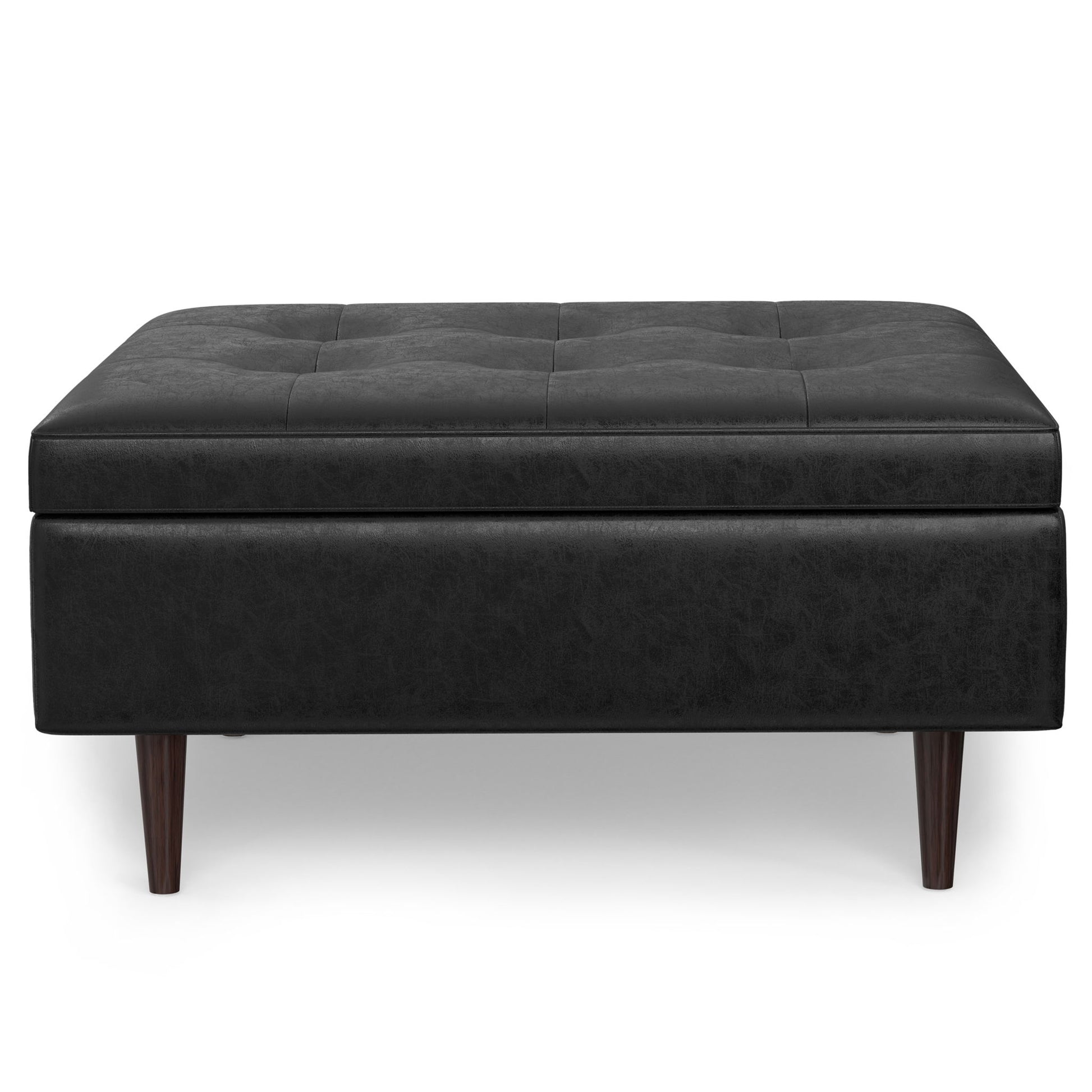 The Shay Large Square Coffee Table Storage Ottoman in black leather features a tufted top with subtle stitching, four wooden legs, and is shown from the front against a white background.