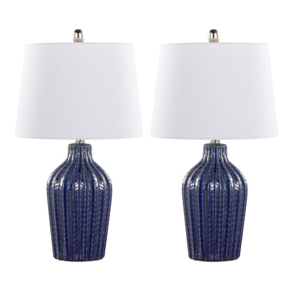 The Rockwell Contemporary Table Lamp set includes two matching lamps with textured dark blue ceramic bases and white tapered fabric shades, each topped with a silver finial, displayed side by side against a white background.