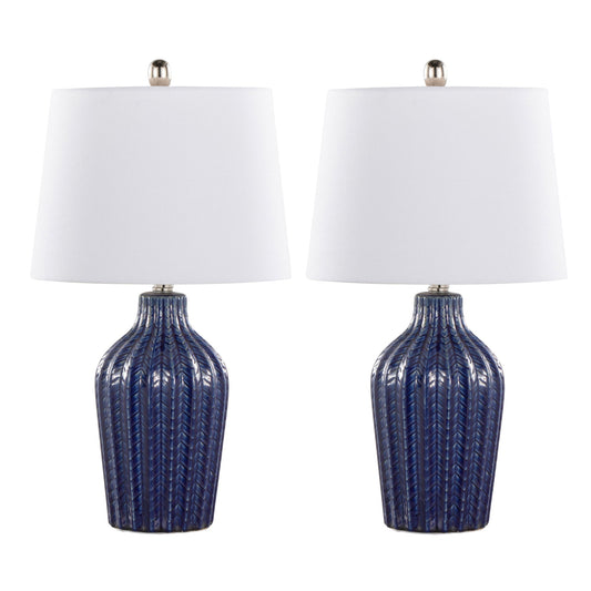 The Rockwell Contemporary Table Lamp set includes two matching lamps with textured dark blue ceramic bases and white tapered fabric shades, each topped with a silver finial, displayed side by side against a white background.