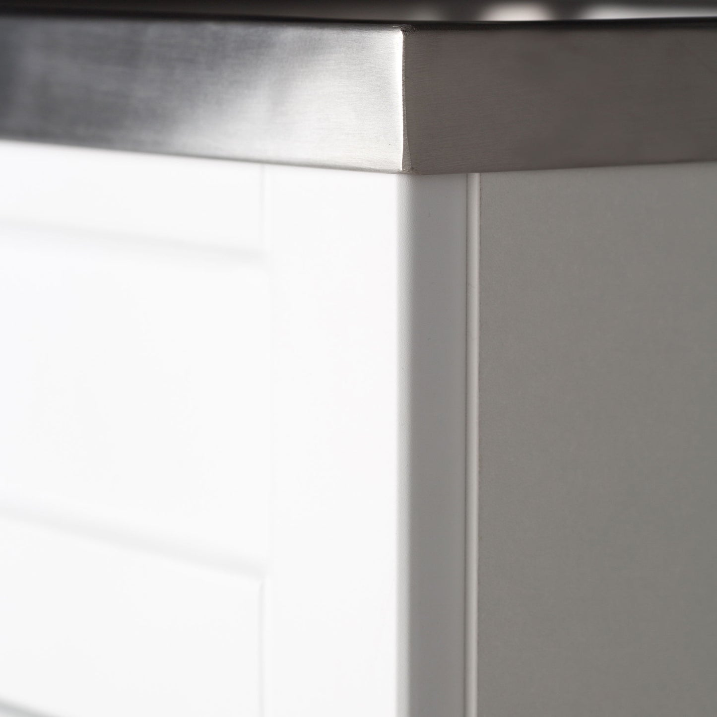 Close-up of the Hennessy - Deluxe Laundry Cabinet With Faucet and Stainless Steel Sink, featuring a white cabinet with a brushed stainless steel countertop that highlights its clean lines and modern, minimalist design.
