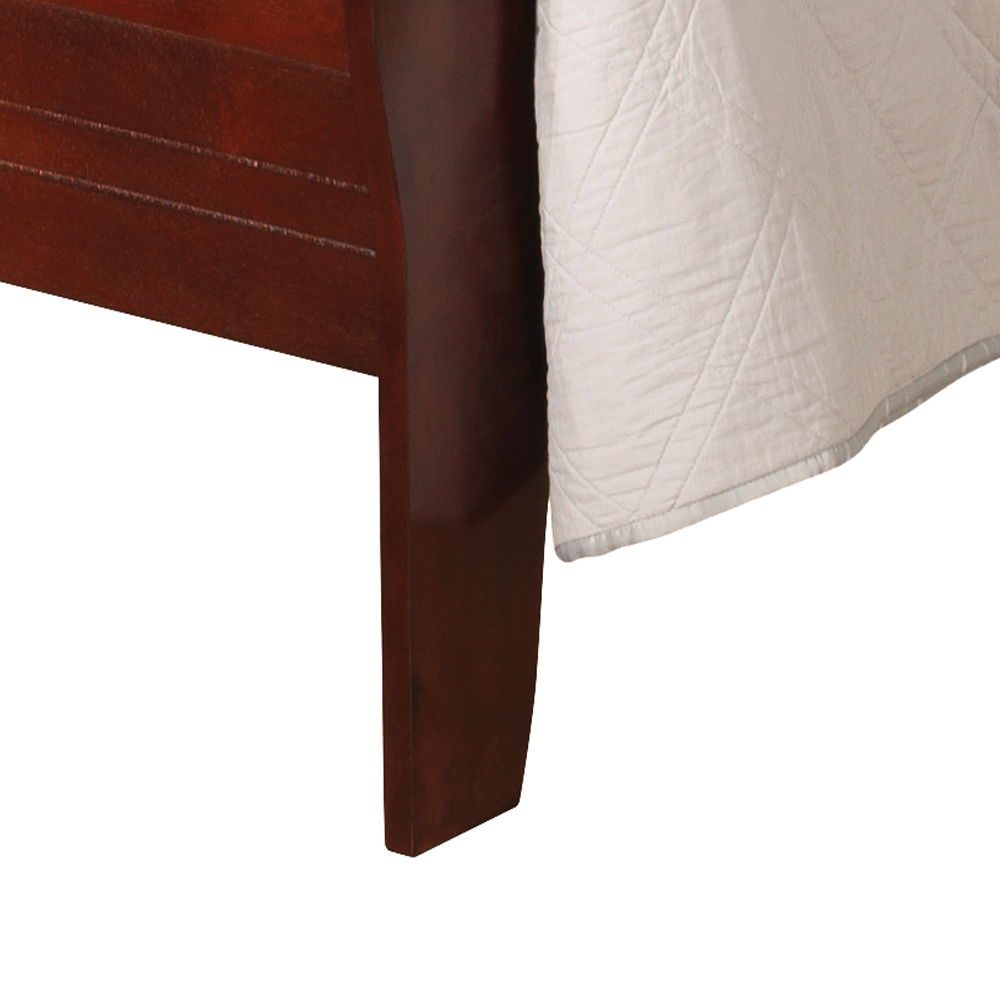 Close-up of the Panel Sleigh Bed's dark, polished wooden leg with a white quilted bedspread draped over the corner.