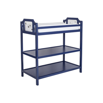 The Celeste - Changing Table is a blue wooden baby changer with two open shelves, star cutout side panels, and a white padded changing mat on top.