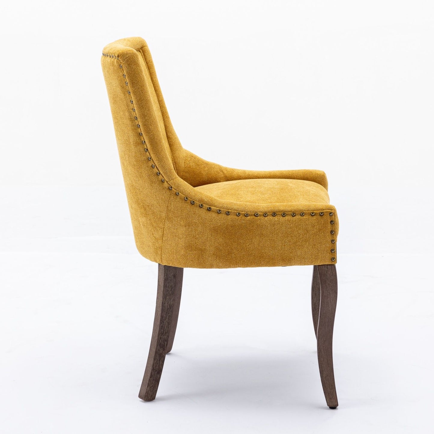 Ultra Side Dining Chair set of 2 features thickened fabric upholstery in mustard yellow, a high back, bronze nailhead trim, and neutrally toned solid wood legs, shown from the side against a plain white background.