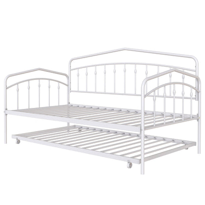 The Fox - Daybed With Twin Trundle features a white metal frame with decorative vertical bars, arched headboard and footboard, plus a pull-out twin trundle bed on casters for extra sleeping space.