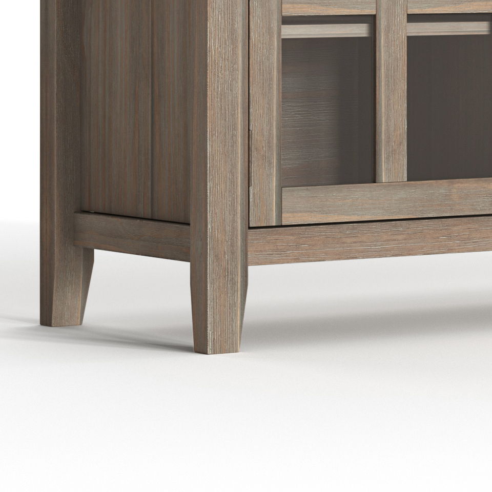 Close-up of the bottom corner of the Artisan - Handcrafted Sideboard Buffet, featuring a light brown finish, glass panel door, visible wood grain, and four legs, shown against a white background.