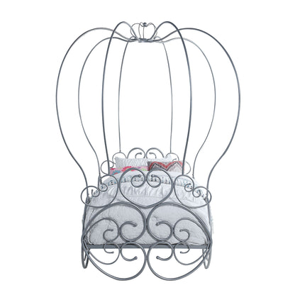 The Priya Twin Bed With Canopy in silver features ornate swirls and tall arches, designed like a whimsical carriage, and comes with a white mattress and decorative pillows.