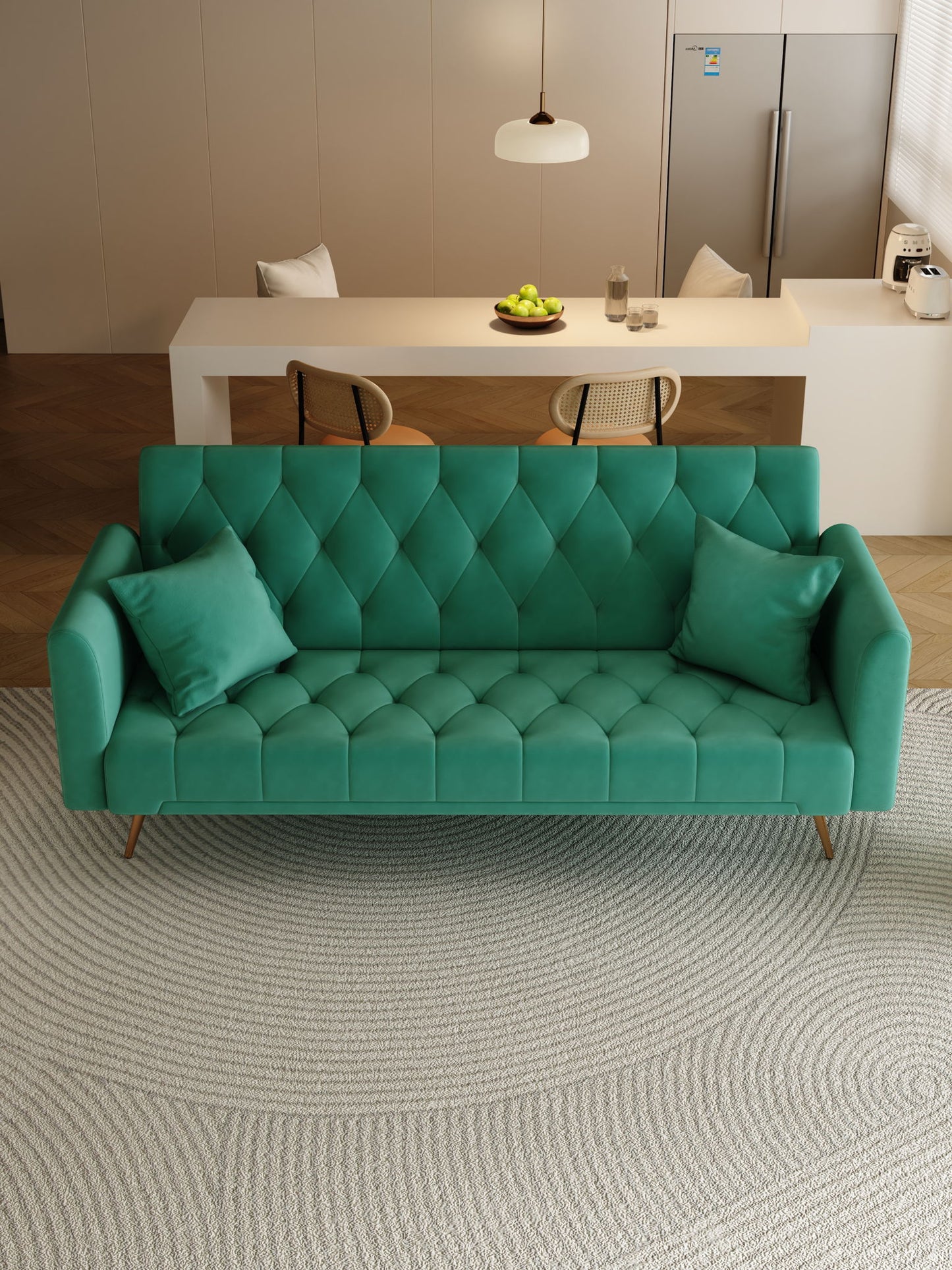 A modern living room features a green Convertible Double Folding Living Room Sofa Bed with two pillows on a textured circular rug. In the background, there's a white table with chairs, a bowl of apples, and a refrigerator.