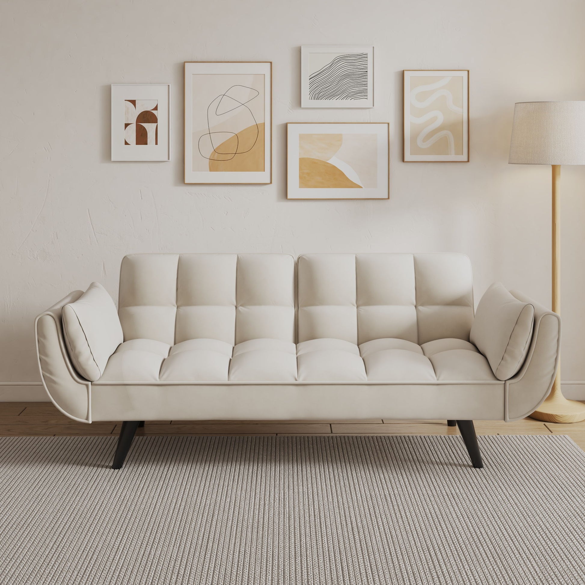 A modern living room featuring the Sofa Soft with two armrests and a throw pillow, abstract art on the wall, a floor lamp, and a light gray textured rug on wooden floors. The minimal decor highlights neutral tones.