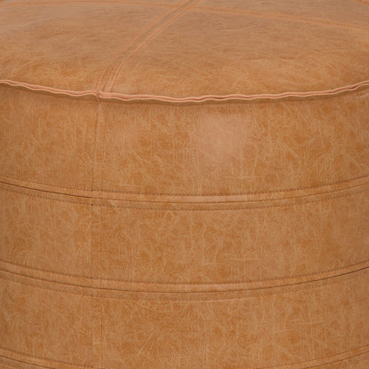 Close-up of the Brody - Round Pouf, featuring tan leather with visible stitching and a smooth, textured surface. The image highlights the top and upper side, showcasing material and seam details.