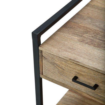 Close-up view of the Riverside - Table featuring a black metal handle and frame, showcasing the corner detail and natural wood grain. The image emphasizes the table's modern, industrial-style design.