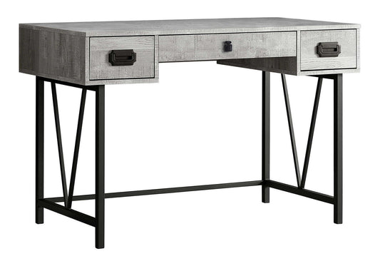This transitional computer desk for home office or laptop use features a gray wood finish, three drawers with black handles, and black metal legs with angular supports for modern style and added storage.