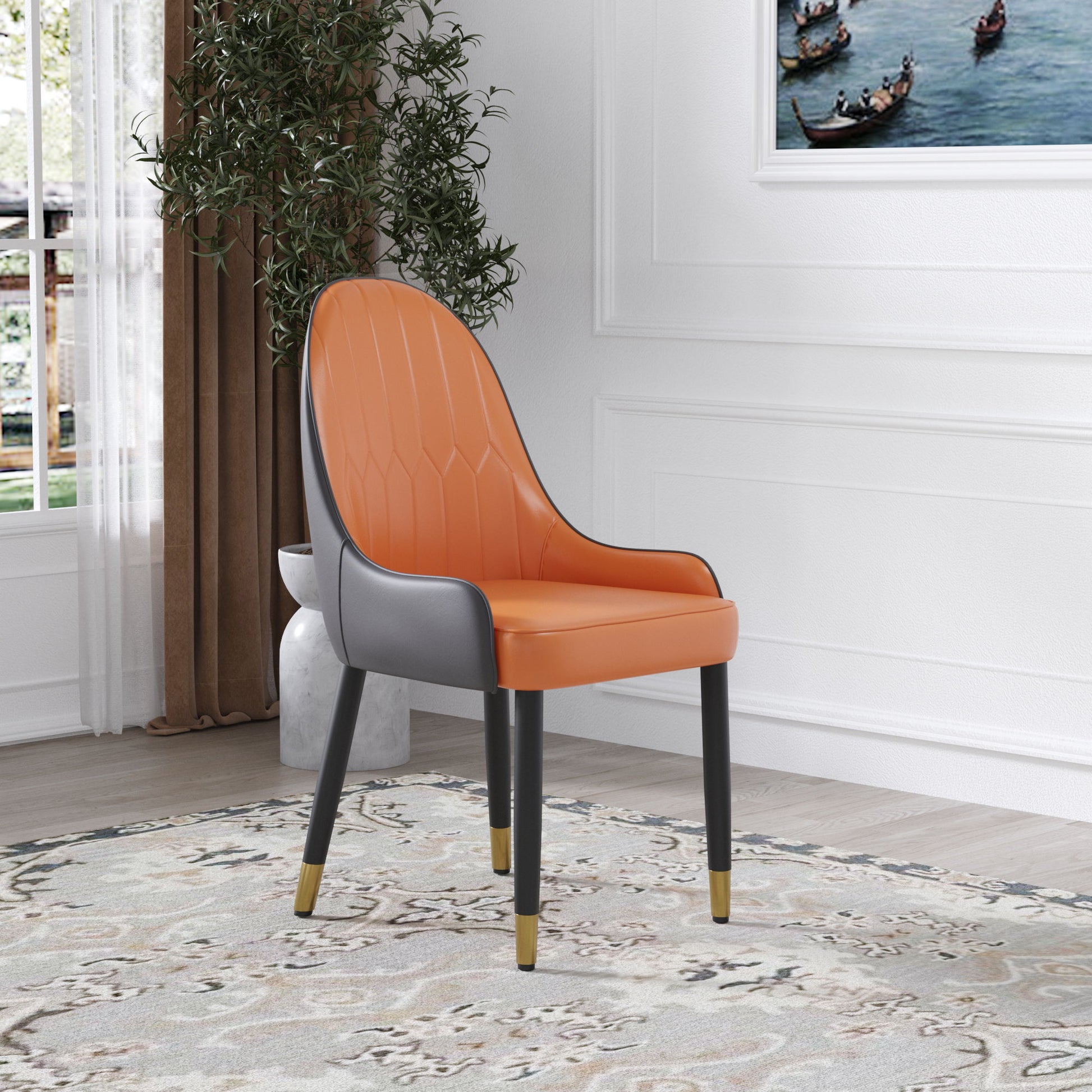 A set of 2 Modern PU Sponge-Filled Dining Chairs with orange seats and backs, gray sides, and black legs with gold tips sits on a patterned rug in a bright room with white walls, a large plant, and a boat painting.
