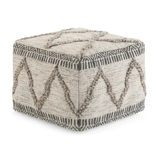 The Sweeney Upholstered Square Pouf features a beige woven fabric exterior with raised geometric patterns in a darker tan, showcasing zigzag and linear designs on its sides and top.