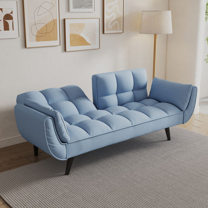 The Sofa Soft has two armrests, throw pillows, and a comfortable fit, perfect for apartments or bedrooms. In a cozy living space, it sits on a gray rug with abstract wall art and a floor lamp behind it.