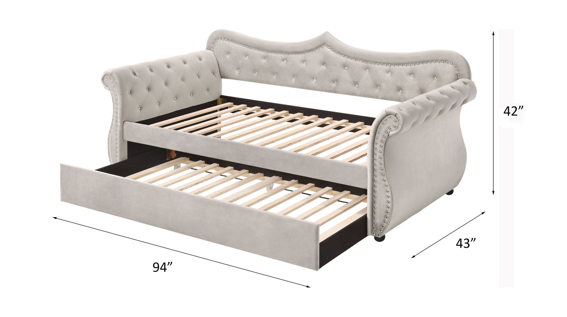 The Adkins Twin Daybed With Trundle in beige features a tufted upholstered design with a curved back and sides, pull-out trundle, black base, and wooden slats. Dimensions: 42” high, 94” long, 43” deep.