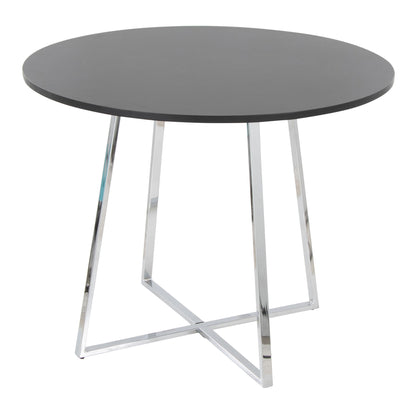 The Cosmo - Canary Contemporary Dining Table features a round dark tabletop and four angled intersecting chrome metal legs, creating a modern minimalist look. Shown against a plain white background.