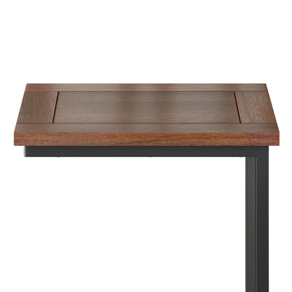 A close-up of the Skyler - Handcrafted C Side Table shows its rectangular wooden tabletop and dark metal leg against a plain white background.