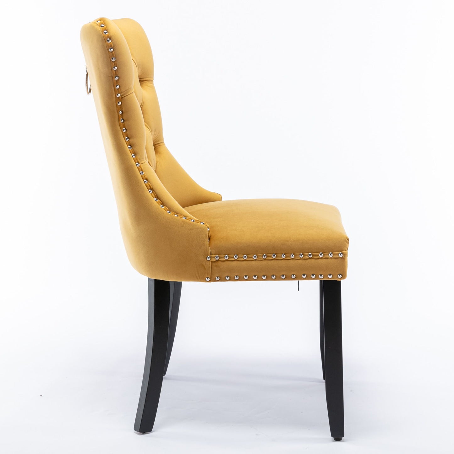 Side view of the Nikki modern velvet upholstered dining chair in mustard yellow, featuring button tufting, nailhead trim, and four dark wood legs; shown against a plain white background. Set of 2.