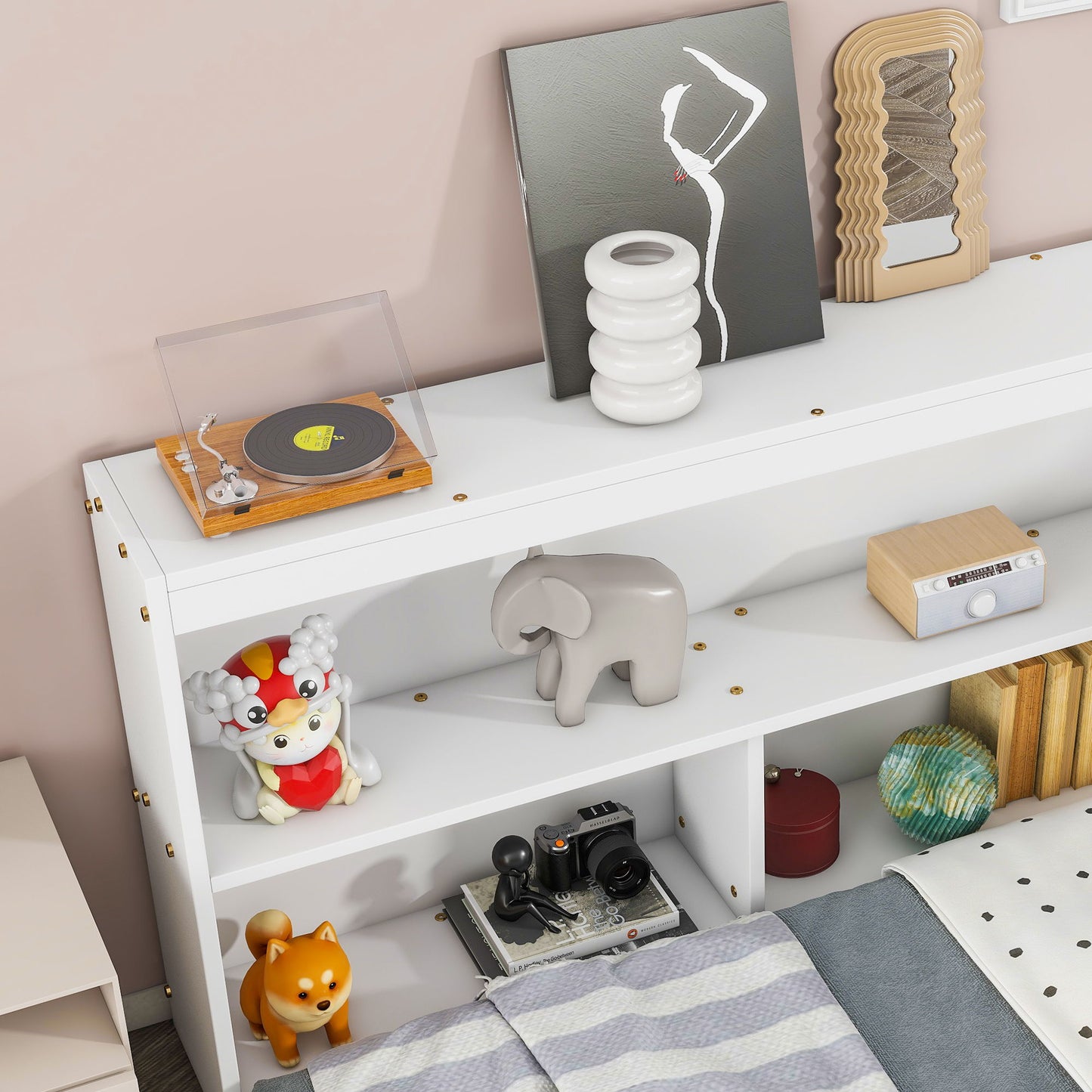 A Floor Bed With L-Shaped Bookcases, Sliding Doors, Without Slats is styled with a vinyl record player, abstract art, white vase, grey elephant figurine, toy dog and cat, books, vintage camera, and decorative objects above the bed.