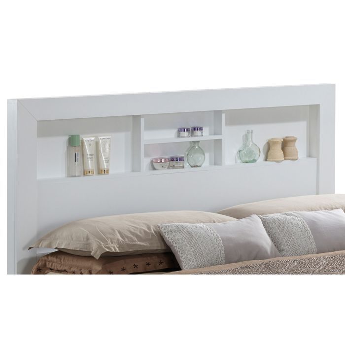 The Bed With Transitional Design Stylish features a white headboard with built-in shelves for bottles, jars, and small containers, positioned behind a bed accented with beige and gray pillows.